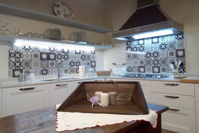 Grande cappa in acciaio, mensole a giorno nella cucina Tablet di Veneta Cucine per agriturismo